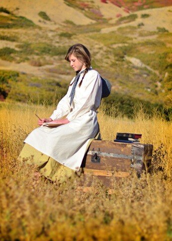Trek participant reflecting and journaling in a field